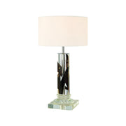 Tall cylindrical acrylic lamp with dark driftwood inside and round shade