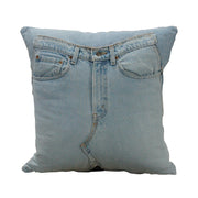 Square throw pillow made from repurposed blue denim with visible seams