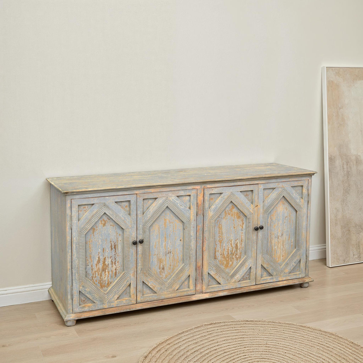 Reclaimed pine carved sideboard with four doors in a distressed light blue finish