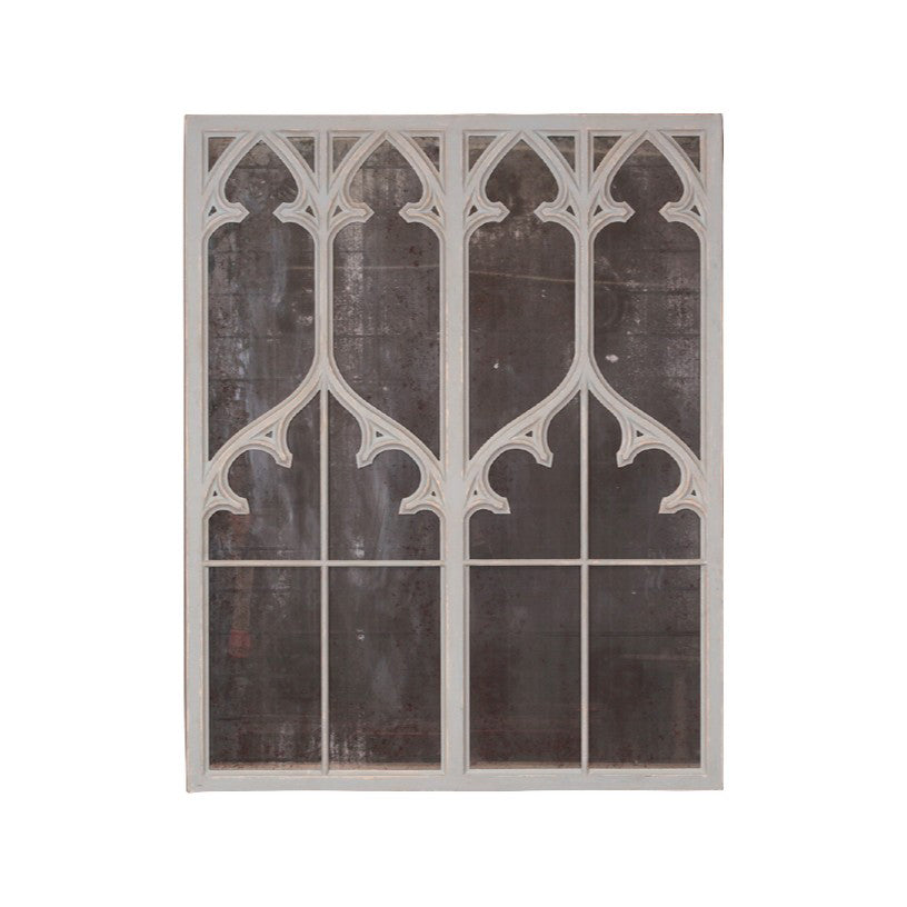 Tall wood mirror with carved Gothic tracery and distressed finish