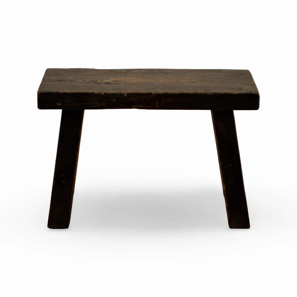 Small stool in elm with a deep black finish and angled legs