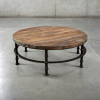 Round reclaimed pine coffee table with plank top on a turned iron base