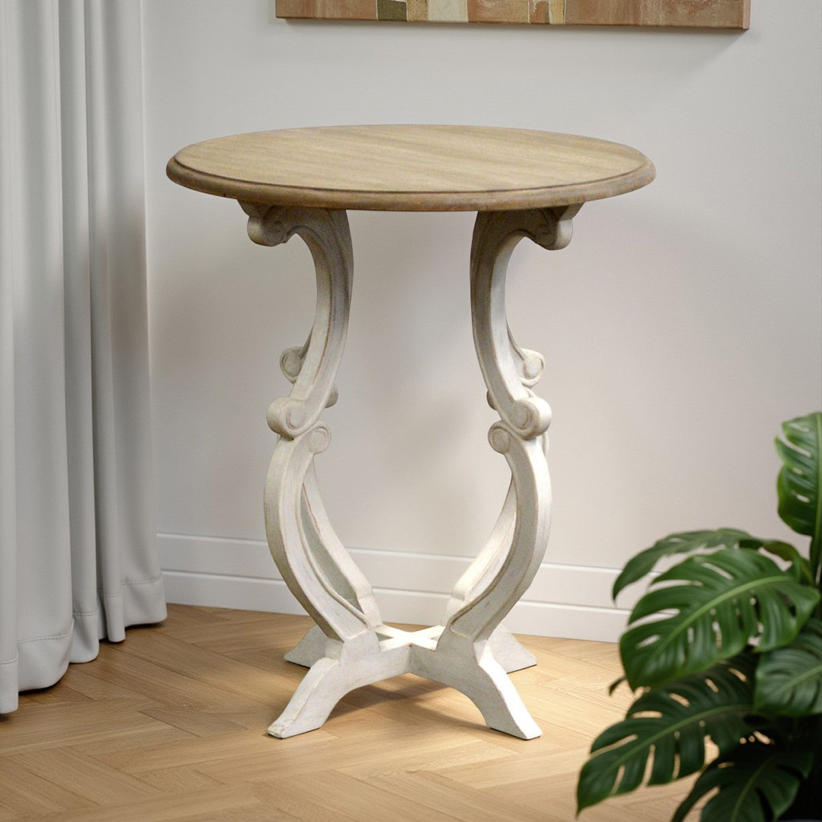 Round-top side table on curved supports in a distressed white finish