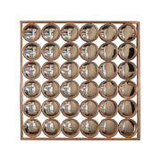 Wall mirror with a grid of convex glass lenses in a metal frame