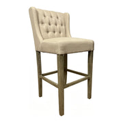 Wing-back barstool upholstered in ecru linen on a wood frame