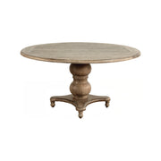 Round oak dining table on a turned pedestal base
