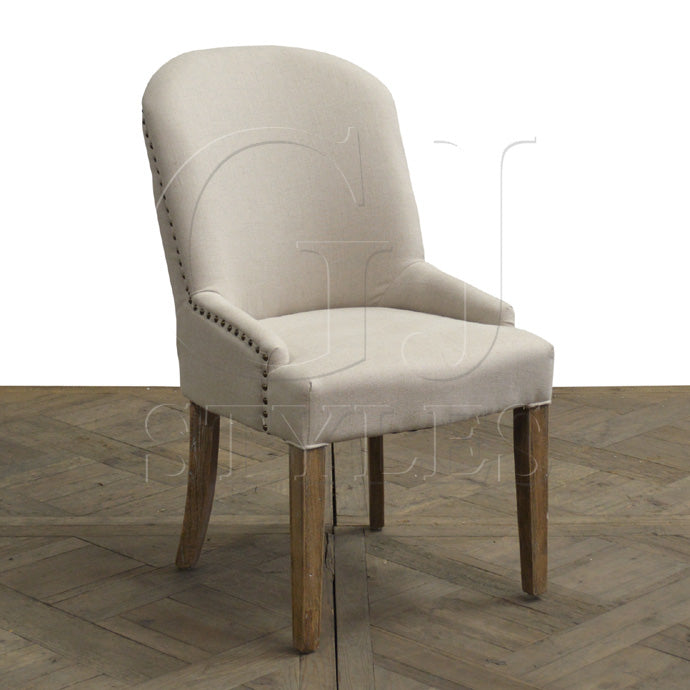 Ecru linen dining chair with a softly rounded back