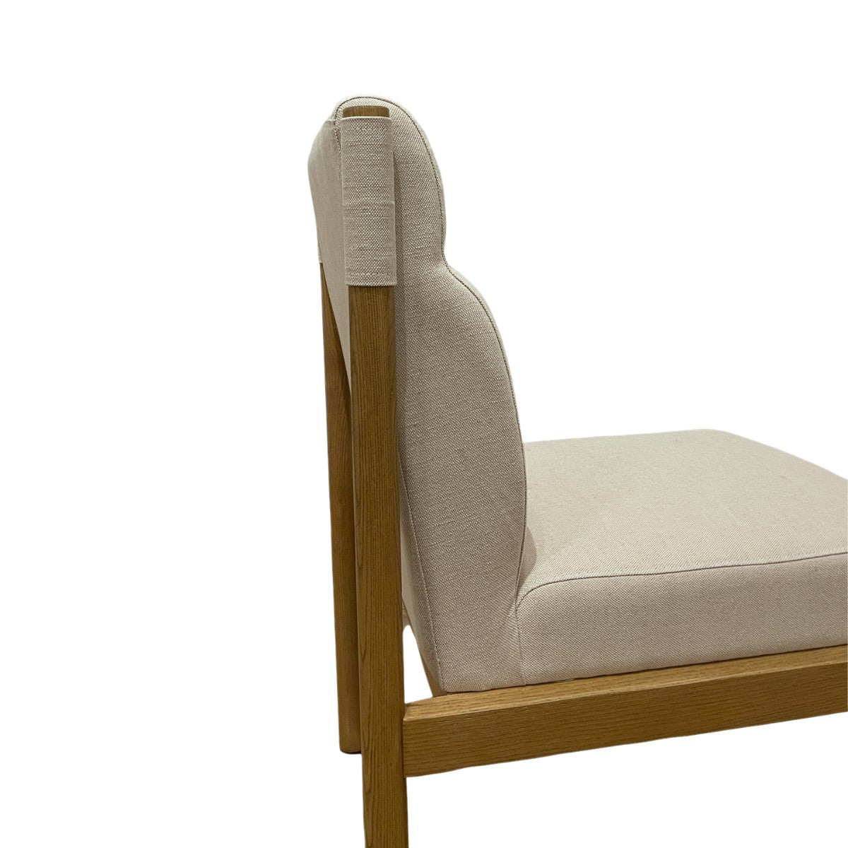 Modern dining chair with a curved upholstered back on ashwood legs