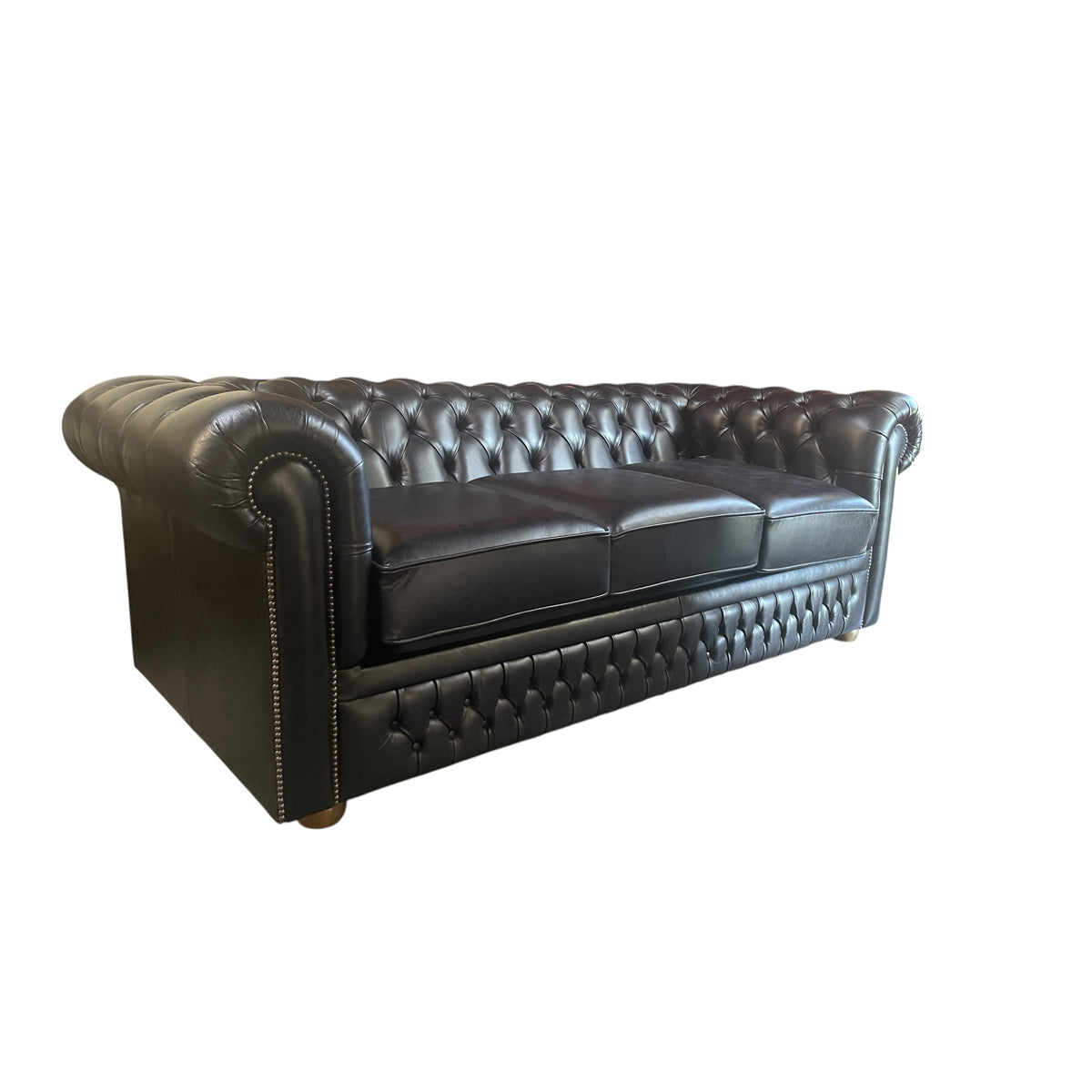Black leather chesterfield sleeper sofa with button tufting and nailhead trim