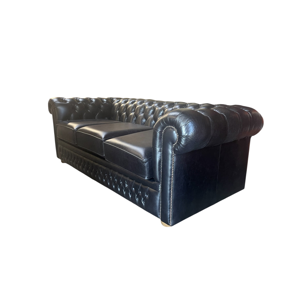 Black leather chesterfield sleeper sofa with button tufting and nailhead trim