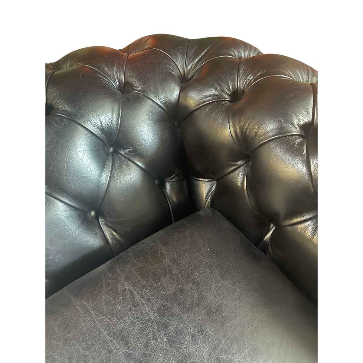 Black leather chesterfield sleeper sofa with button tufting and nailhead trim