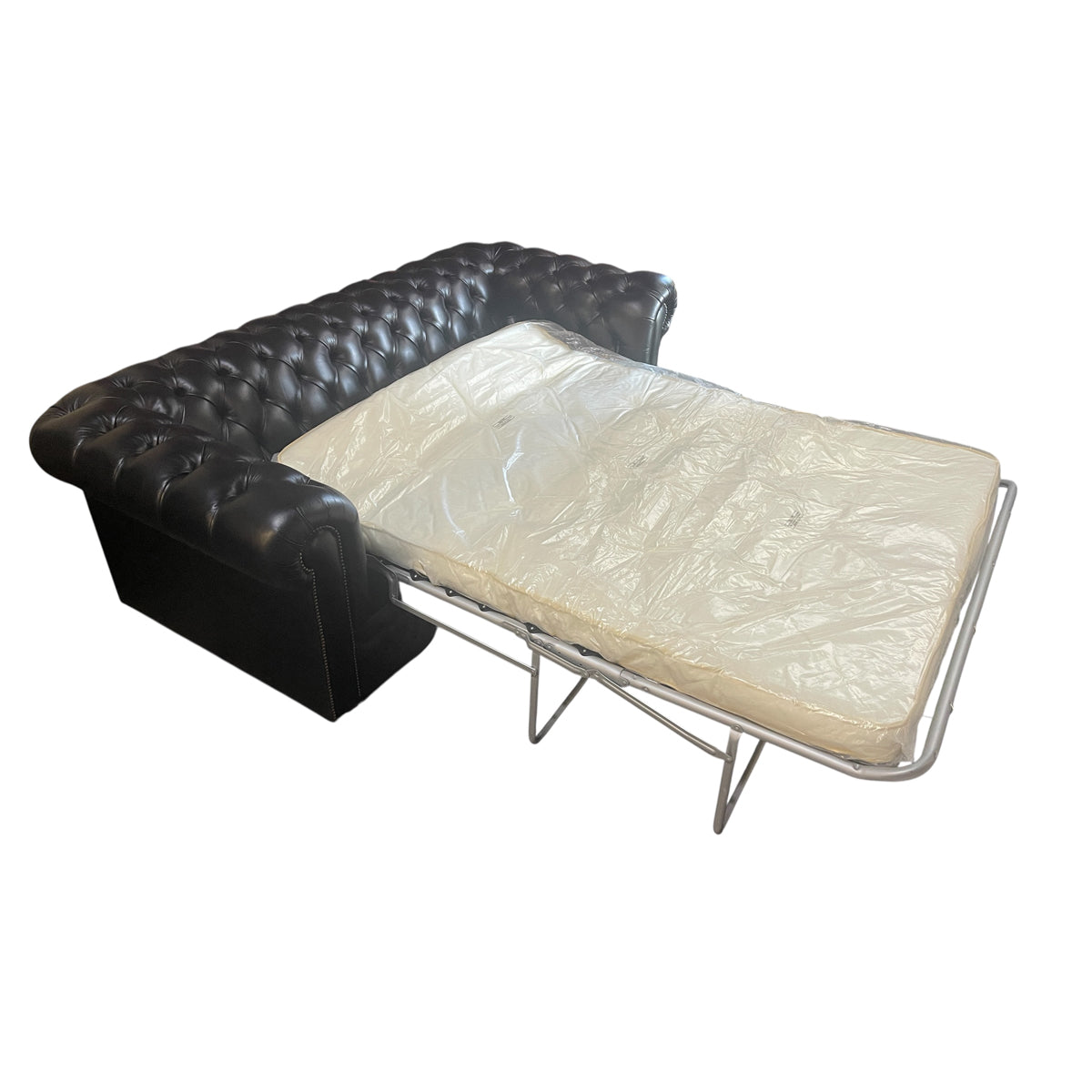 Black leather chesterfield sleeper sofa with button tufting and nailhead trim
