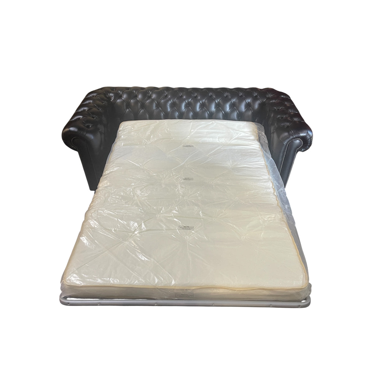 Black leather chesterfield sleeper sofa with button tufting and nailhead trim