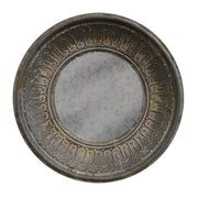 Round mirror in a heavily distressed metal frame with patina