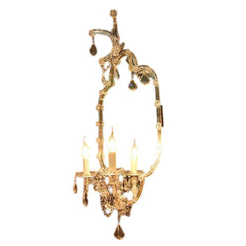 Iron wall sconce with branching arms, candle sockets and antique rust finish