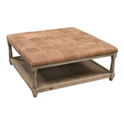 Tufted leather ottoman on an oak frame with a lower shelf.