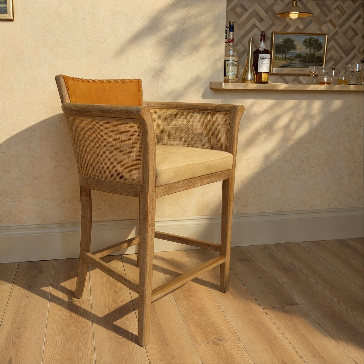 Counter chair with brown leather seat, cane arm panels and oak frame