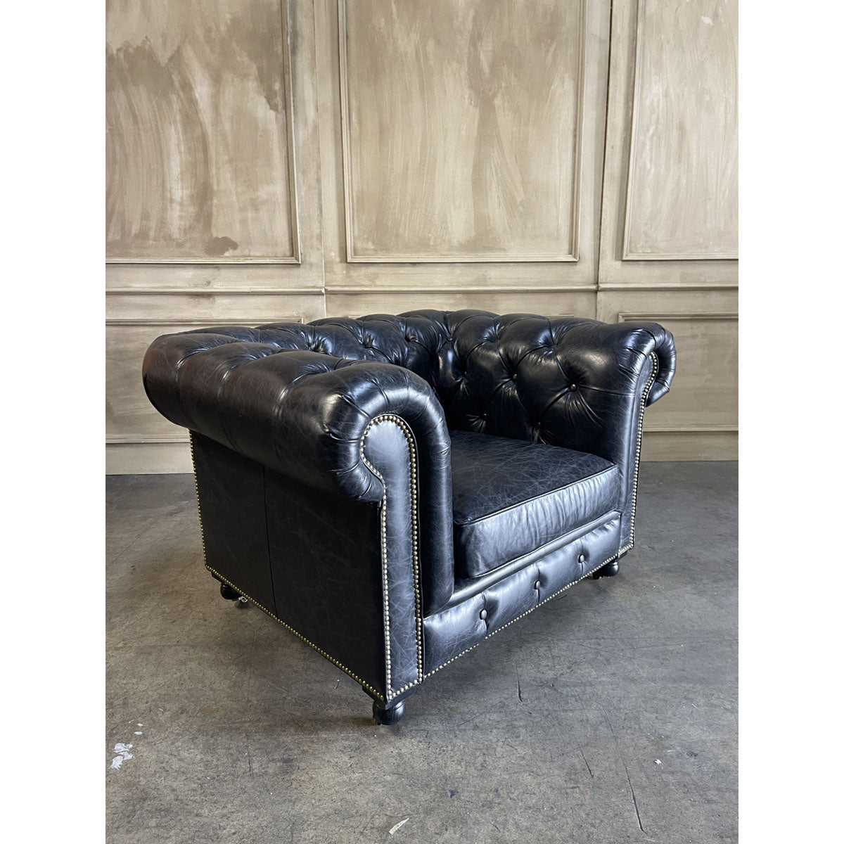 Chesterfield one-seater in espresso leather with deep button tufting and rolled arms