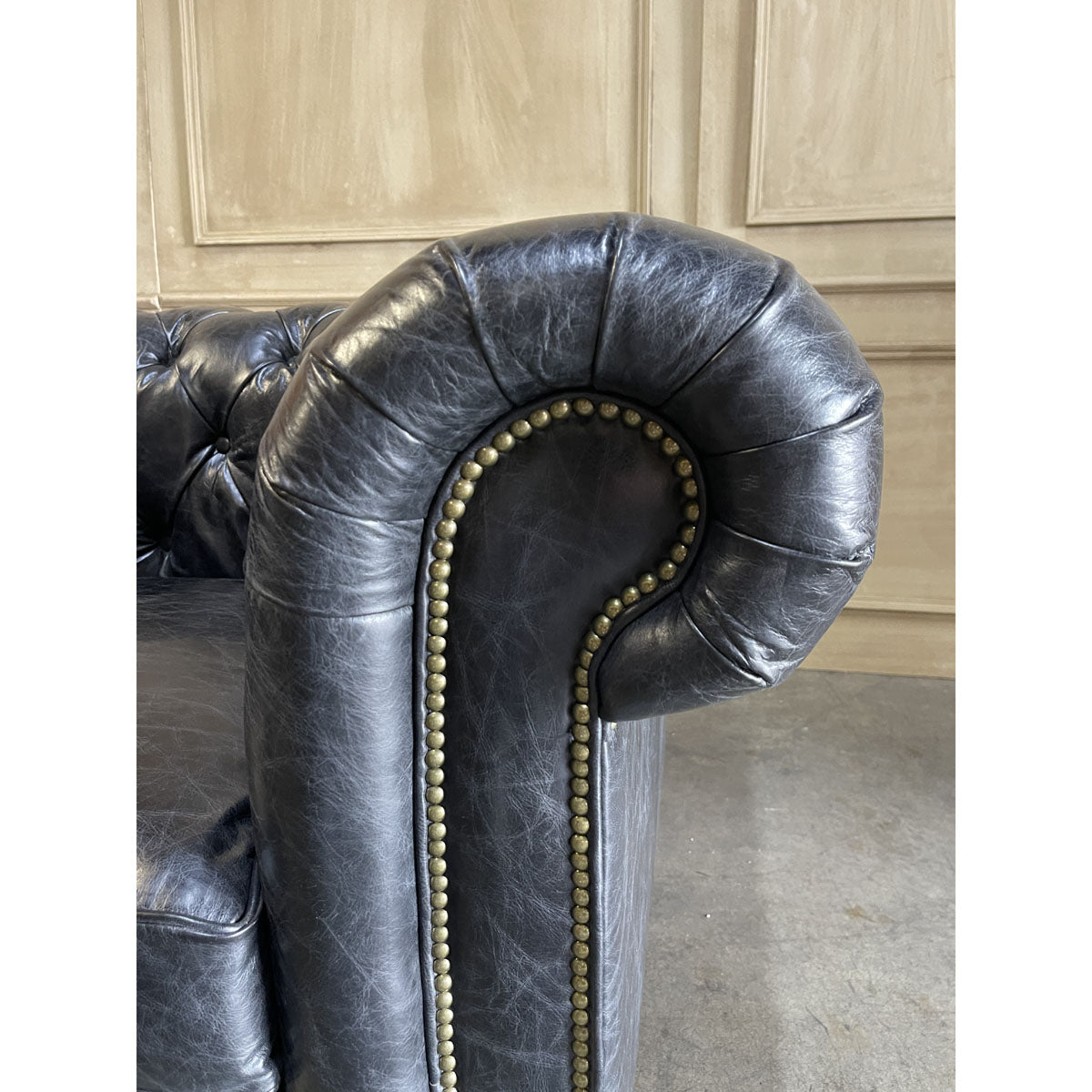Chesterfield one-seater in espresso leather with deep button tufting and rolled arms