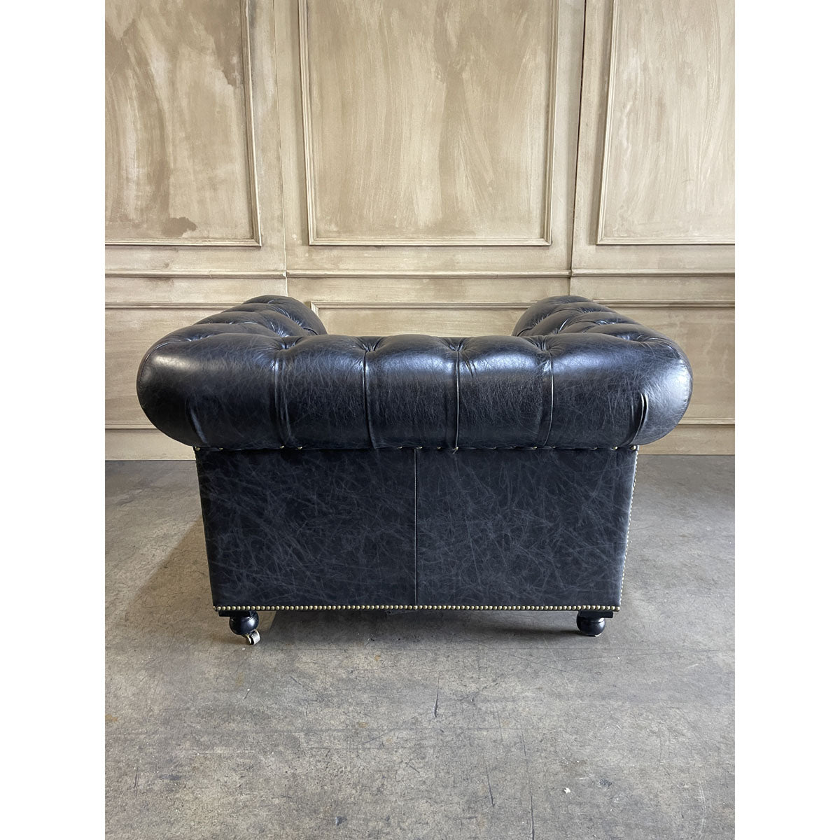 Chesterfield one-seater in espresso leather with deep button tufting and rolled arms