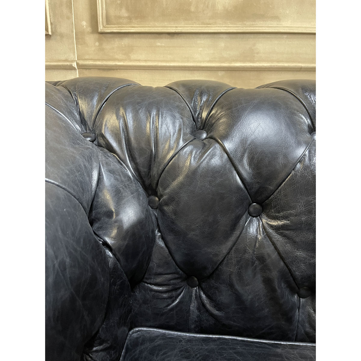 Chesterfield one-seater in espresso leather with deep button tufting and rolled arms