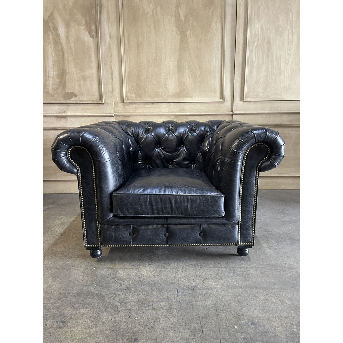 Chesterfield one-seater in espresso leather with deep button tufting and rolled arms