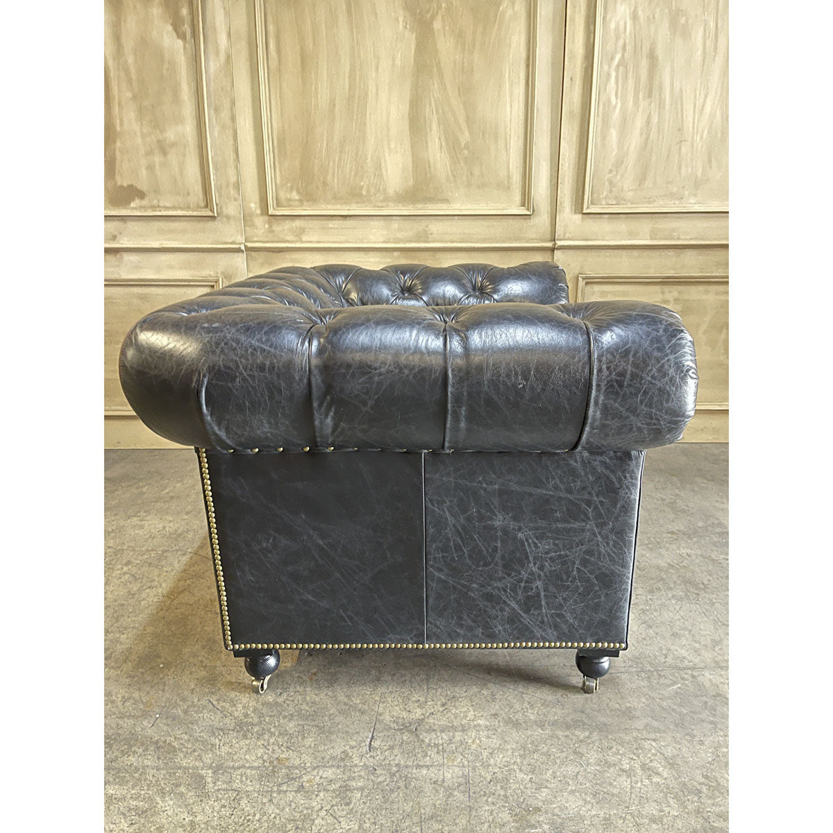 Chesterfield one-seater in espresso leather with deep button tufting and rolled arms