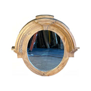 Rounded mirror framed in layered reclaimed pine