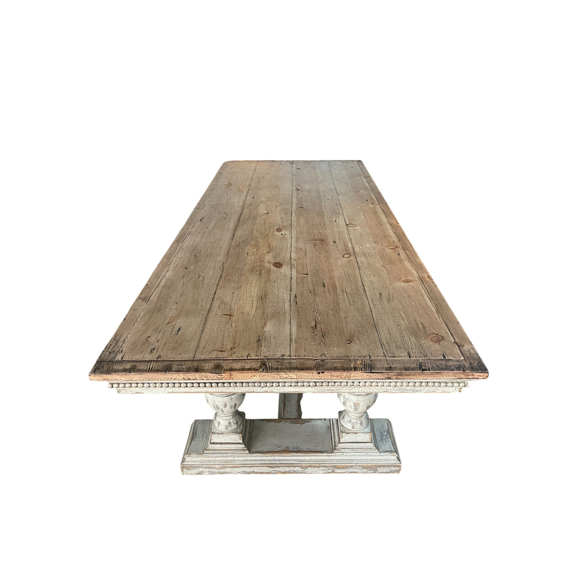 Reclaimed pine dining table with plank top and turned trestle base