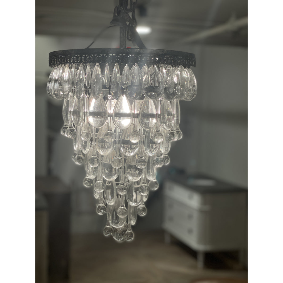 Small tapered chandelier with layered suspended glass teardrops