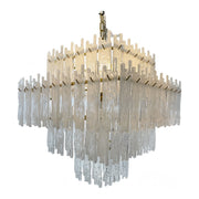 Lacy brass chandelier with dense stepped tiers of suspended glass elements