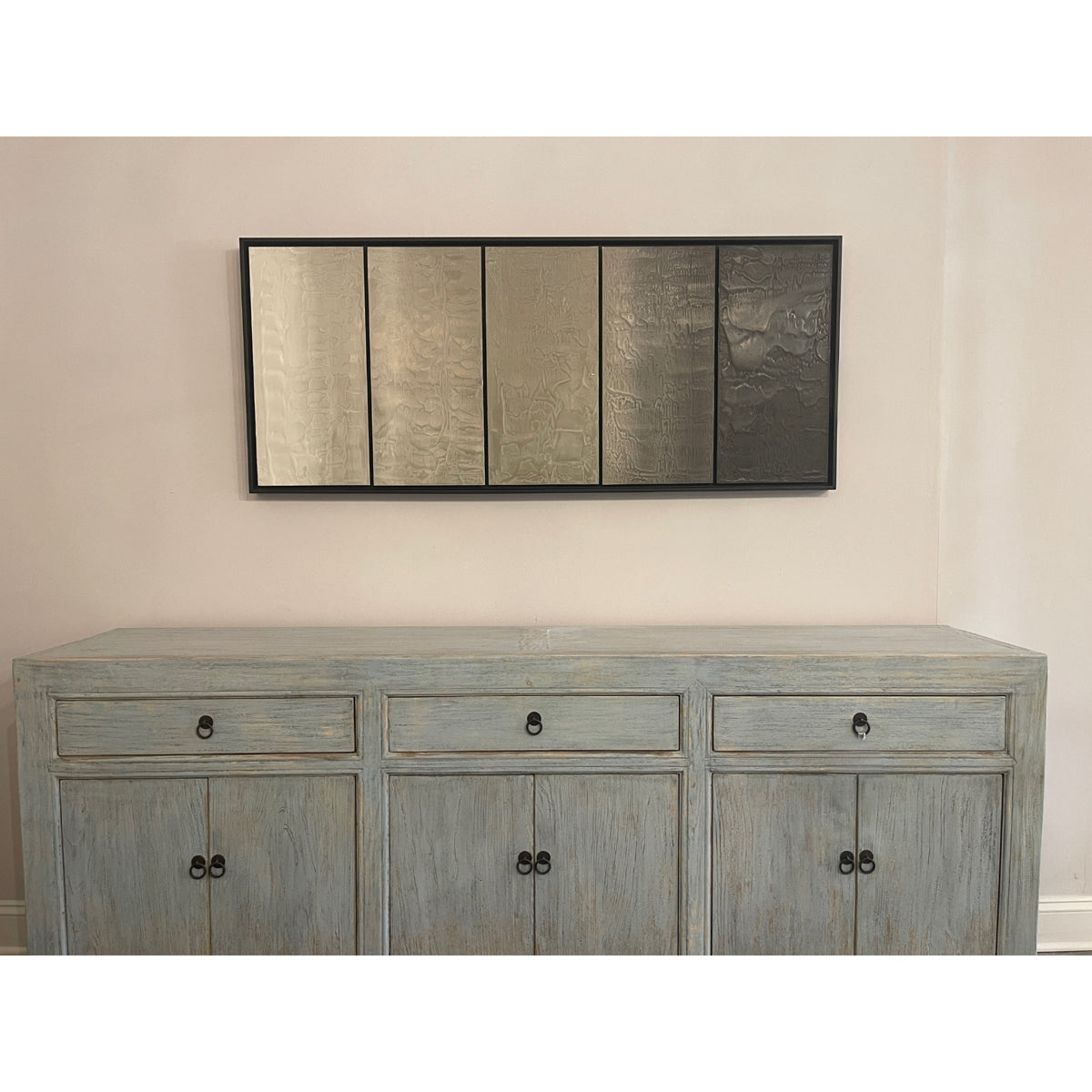 Multi-panel photographic work on a horizontal row of concrete panels
