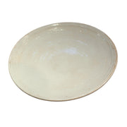Shallow white glazed porcelain plate with a raised rim