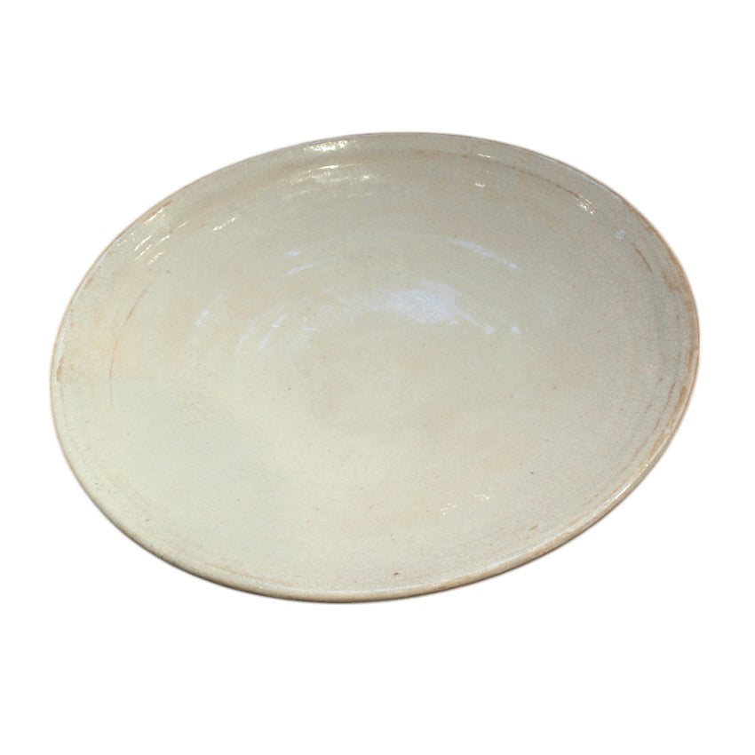 Shallow white glazed porcelain plate with a raised rim