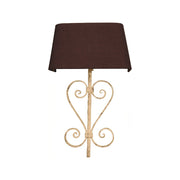 Decorative iron wall lamp with open scrollwork frame and fabric shade