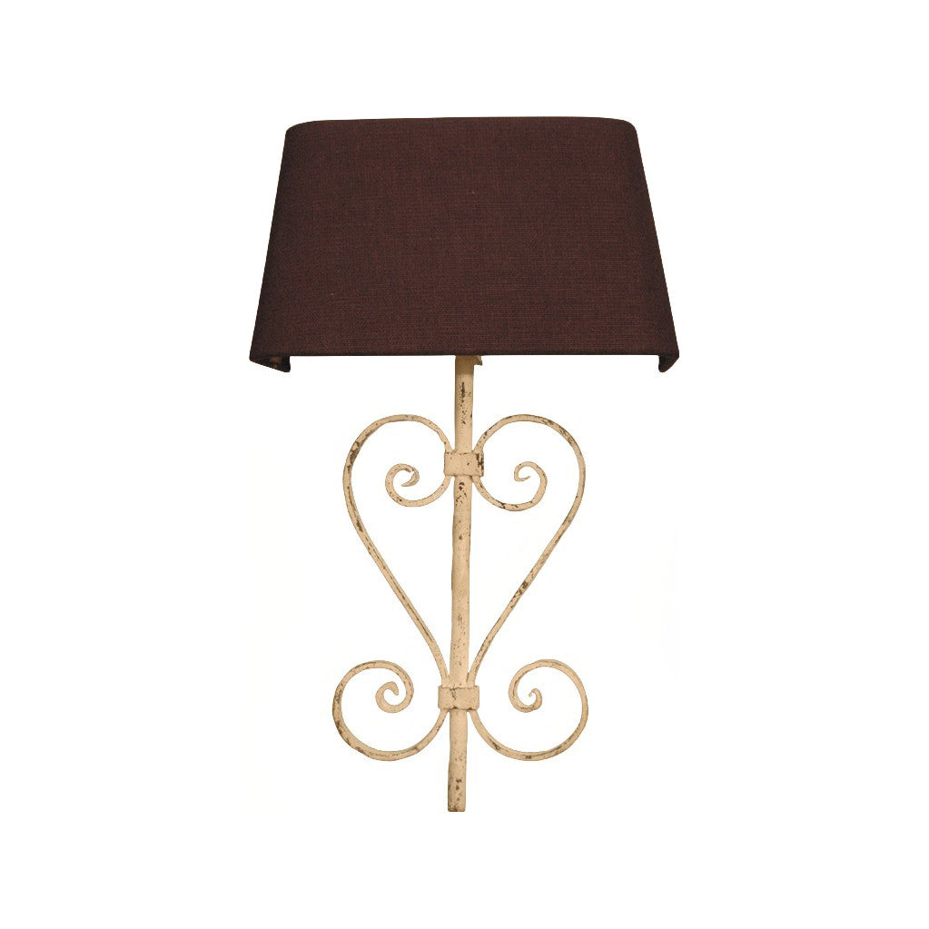 Decorative iron wall lamp with open scrollwork frame and fabric shade