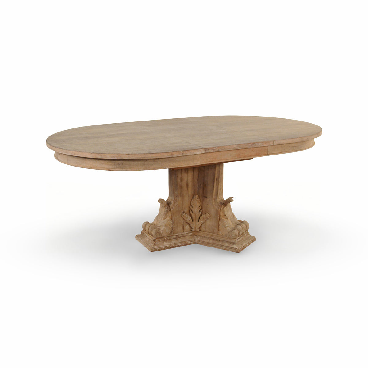Oval extending dining table in reclaimed wood on a carved pedestal base