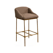 Barstool with a taupe linen seat and back on a slender metal frame