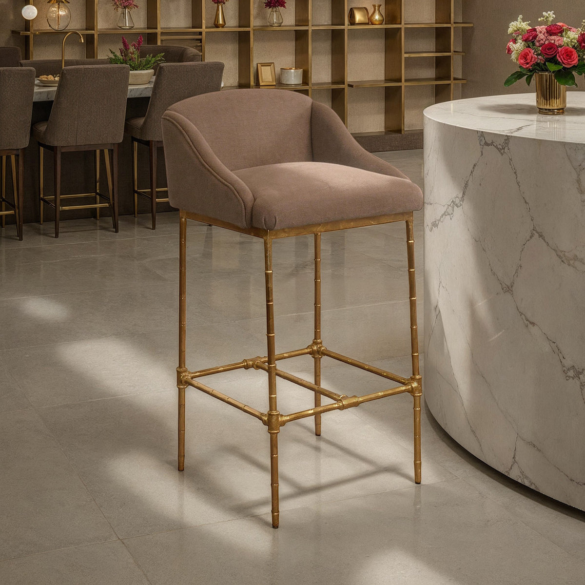 Barstool with a taupe linen seat and back on a slender metal frame