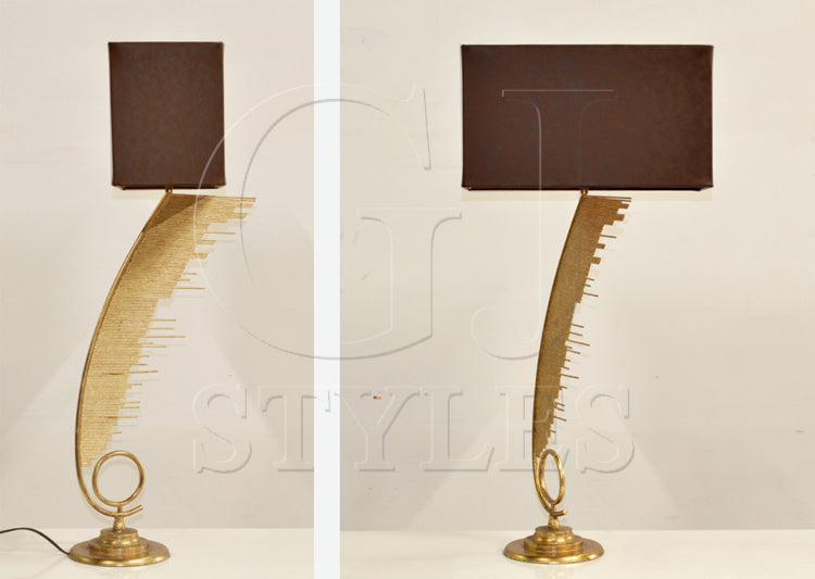 Ahab table lamp with curved asymmetric metal arm and leather shade