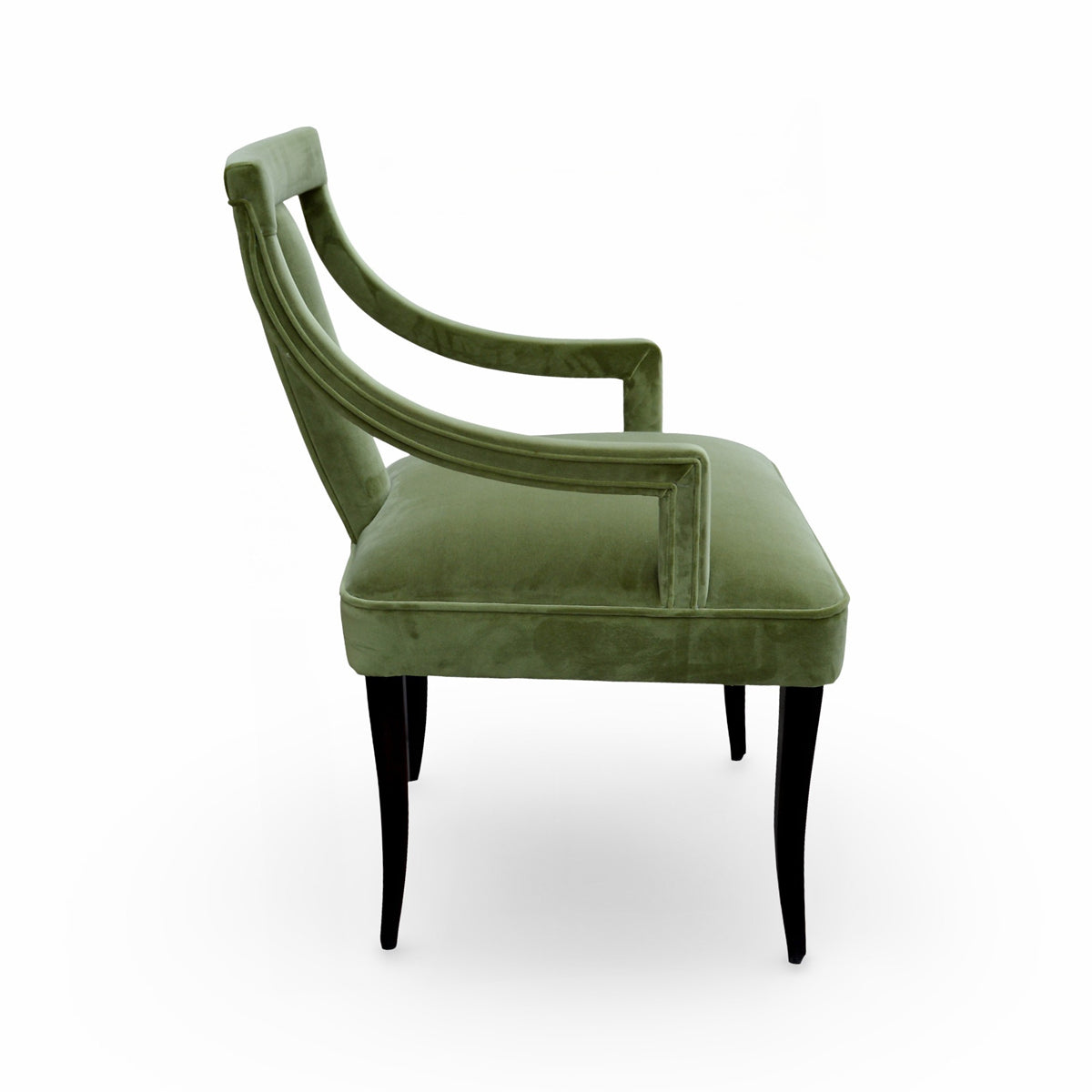 Arm chair upholstered in green velvet with curved arms on a birch frame