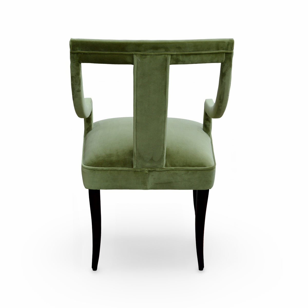 Arm chair upholstered in green velvet with curved arms on a birch frame