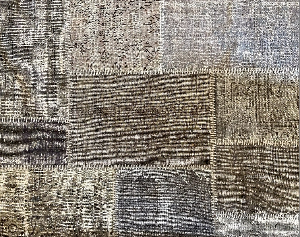 Vintage Turkish patchwork rug in soft, muted wool tones.