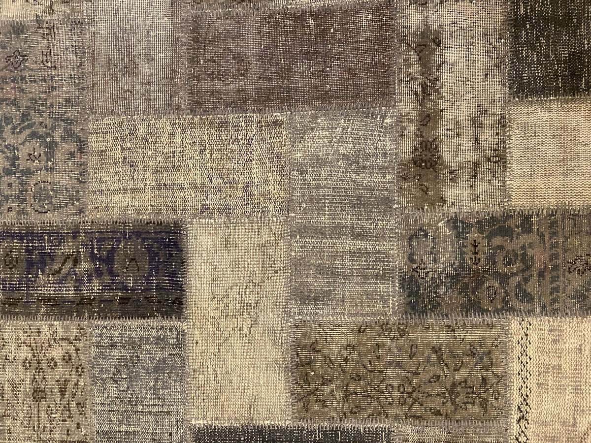 Vintage Turkish patchwork rug in a neutral wool palette.