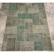 Large vintage Turkish patchwork rug in subtle green wool tones.