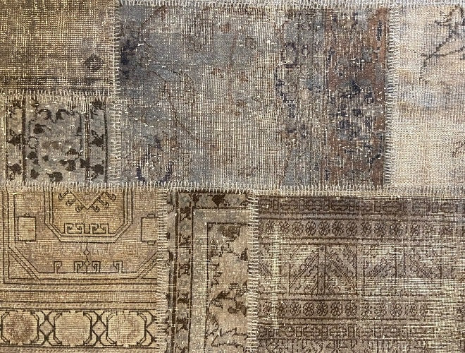 Vintage Turkish patchwork rug in muted blue-grey wool tones.