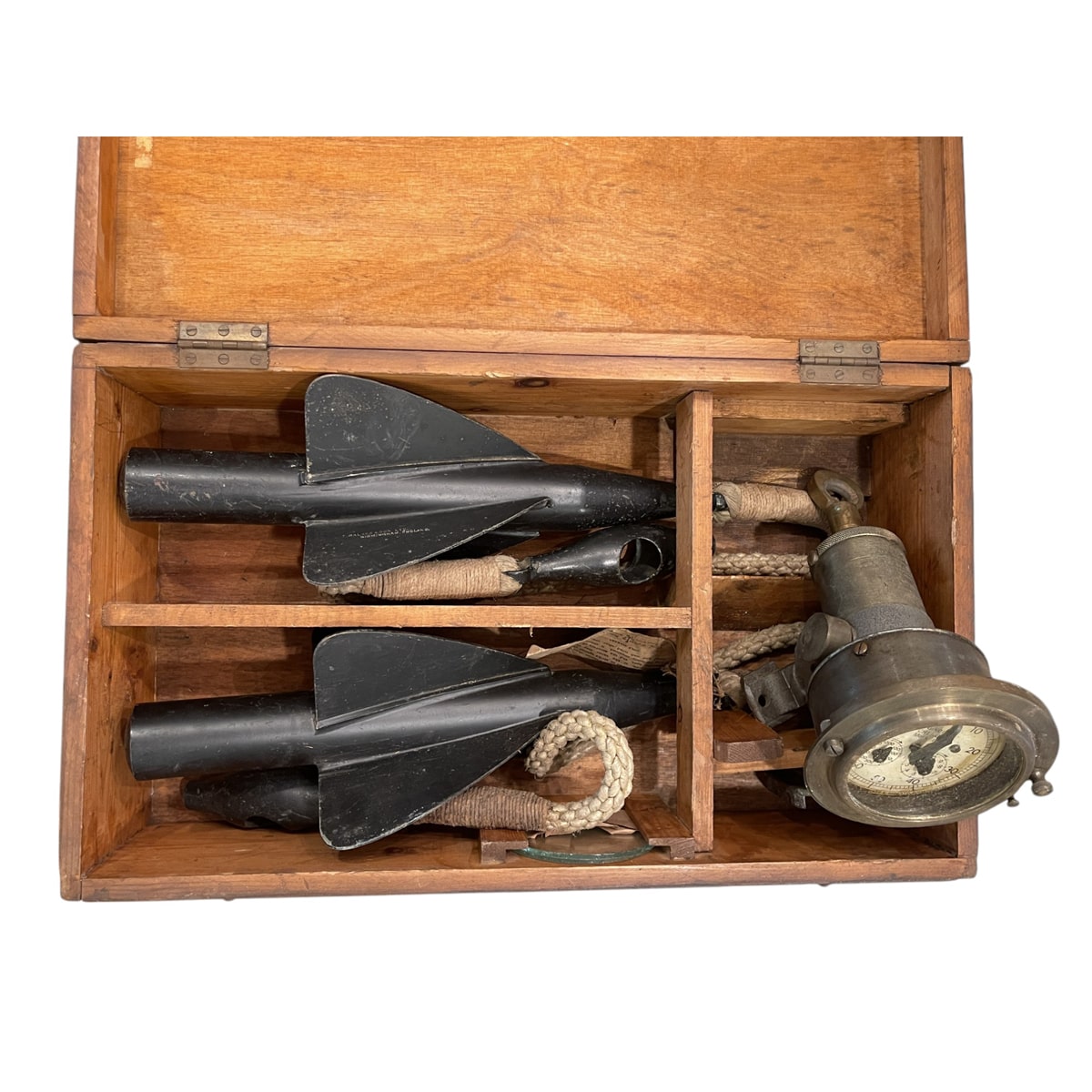 Fireplace log set of salvaged ship brass in a wooden storage box