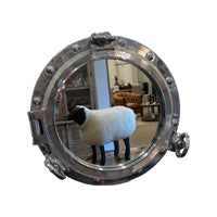 Mirror in a round salvaged aluminum opening ship porthole