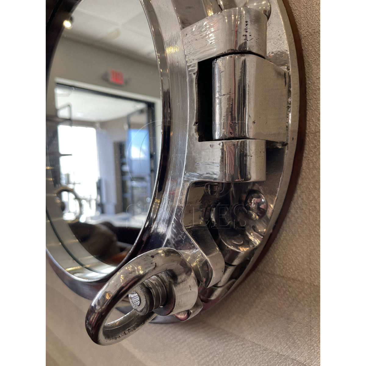 Mirror in a round salvaged aluminum opening ship porthole
