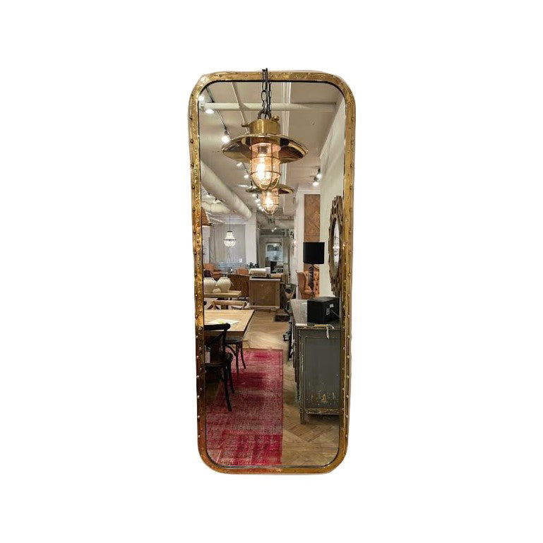Overscaled mirror set in a salvaged brass ship porthole with patina